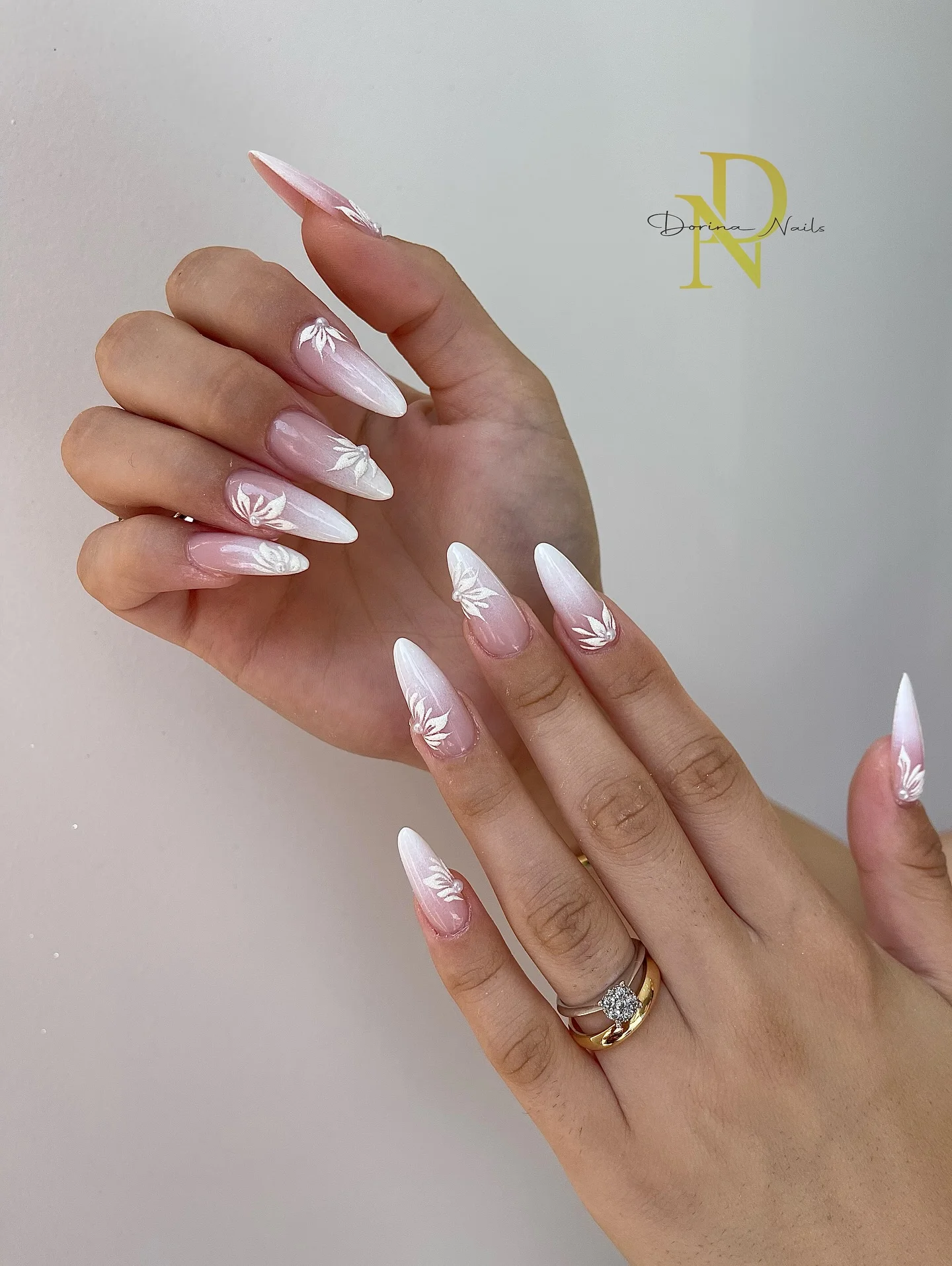 fall wedding nails 2026 Pearl White Gradient Bridal Nails With Delicate Leaf Art
