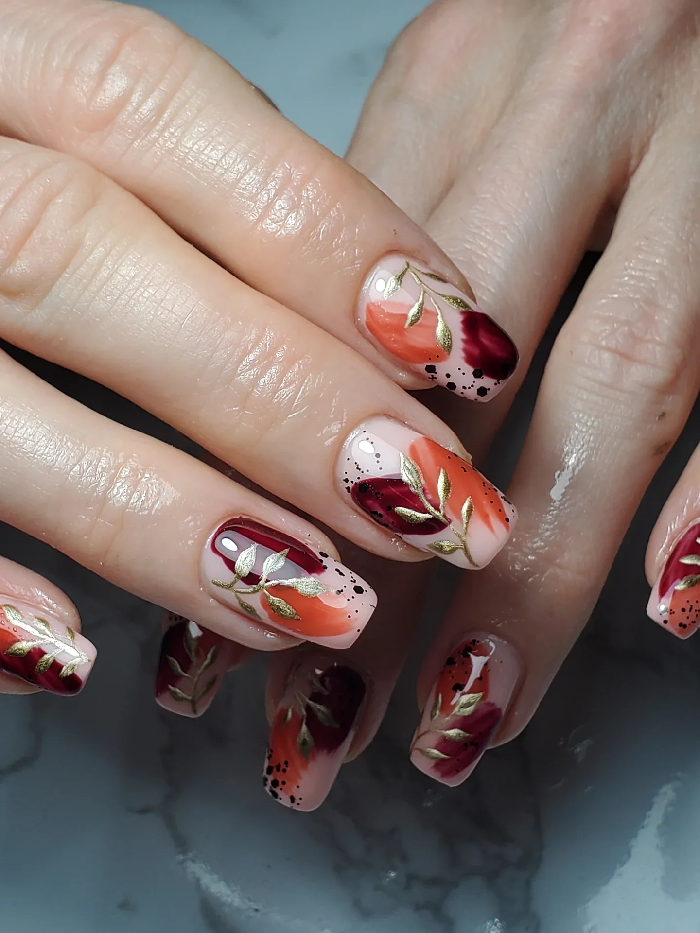 fall short coffin nails designs 2026 Burnt Orange And Burgundy Nails With Gold Botanical Details