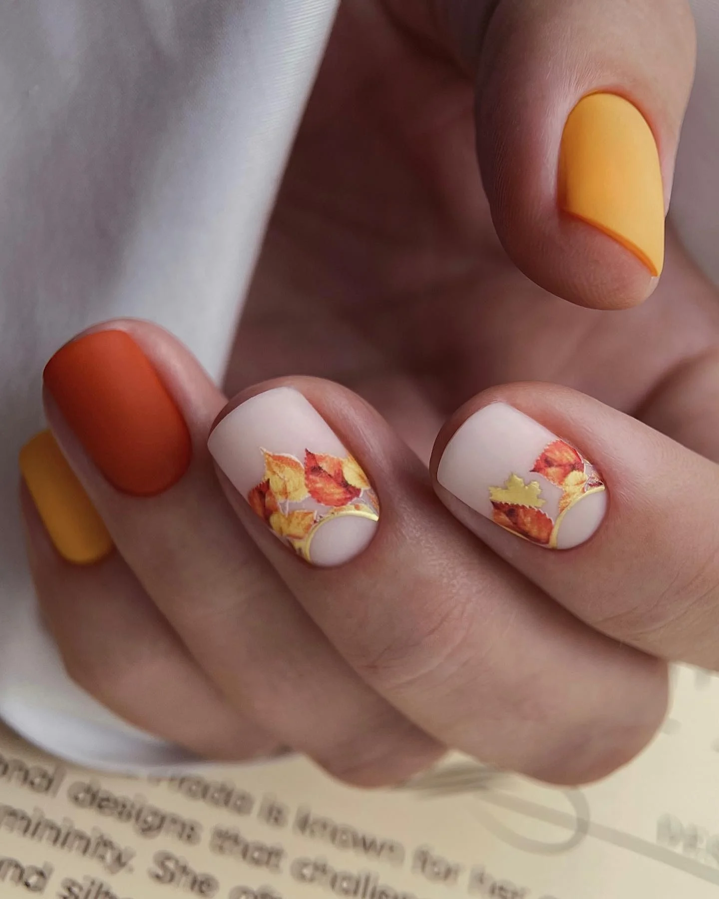 matte fall nails design 2026 Burnt Orange Nails With Autumn Leaf Details