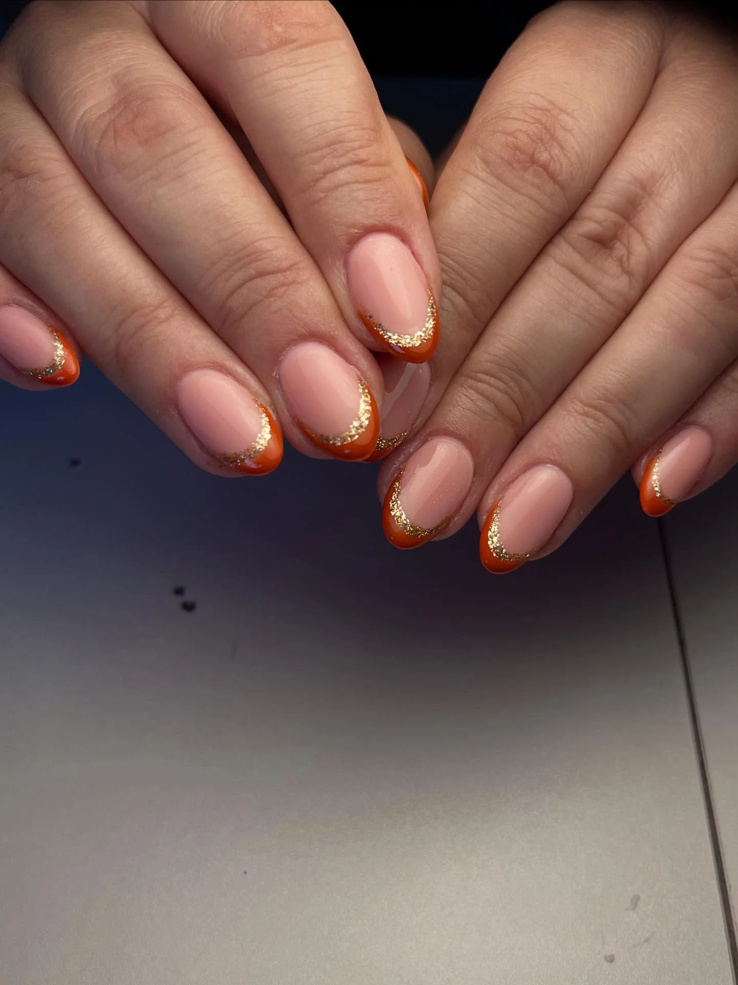 fall french nails 2026 Burnt Orange French Tips With A Touch Of Gold Sparkle