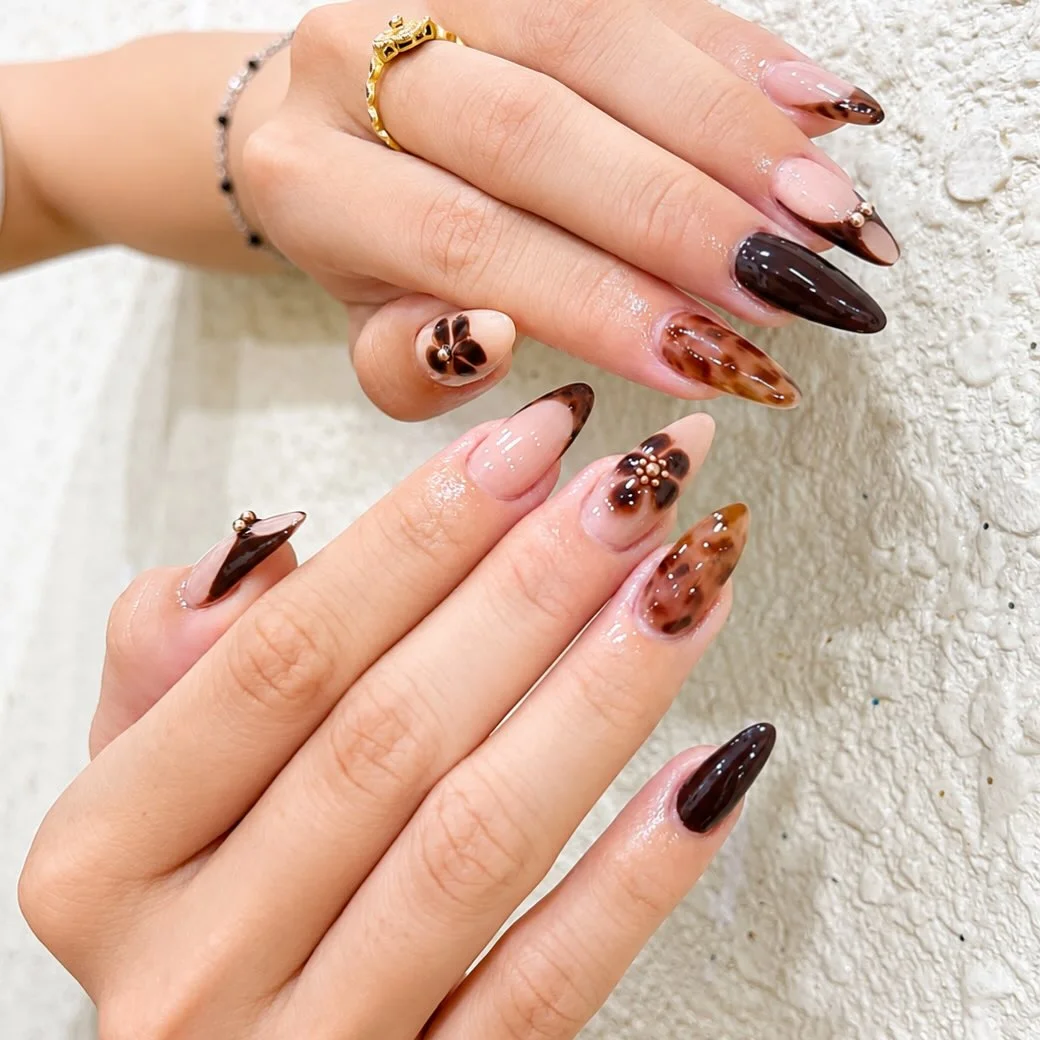 fall gel nails ideas 2026 Chocolate Tortoiseshell Almond Nails With Floral Accents