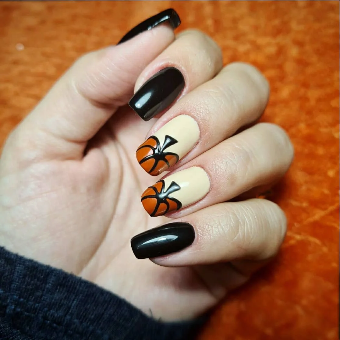 fall nails with pumpkins 2026 Glossy Black And Cream With Tiny Pumpkin Accents