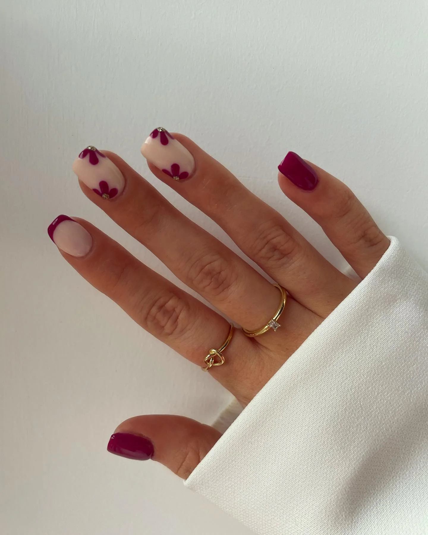 fall burgundy nails with design Soft Nude French Tips With Burgundy Petal Accents