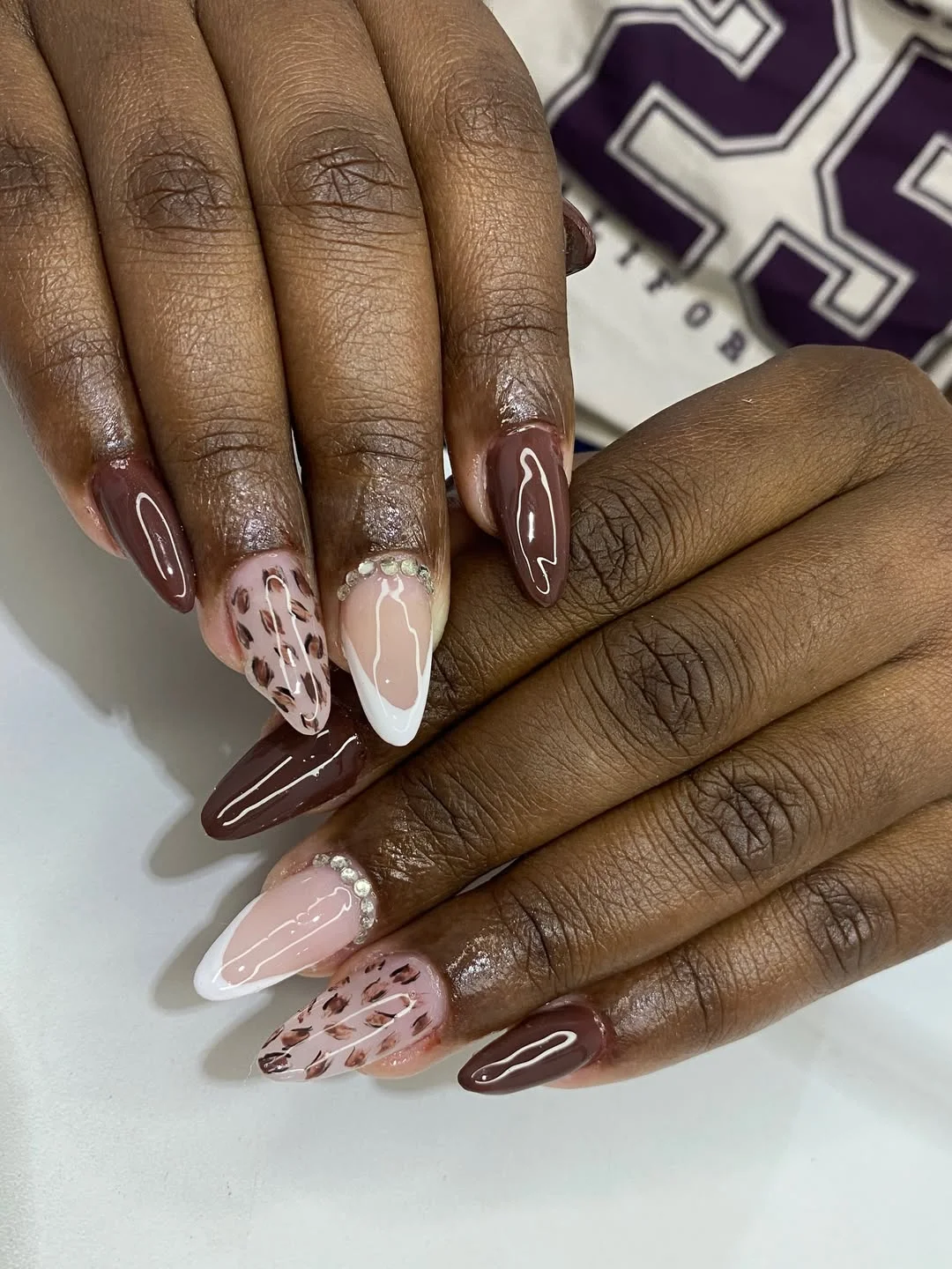 fall nails for brown skin tone Glossy Chocolate Nails With Soft Leopard And Pearl Accents