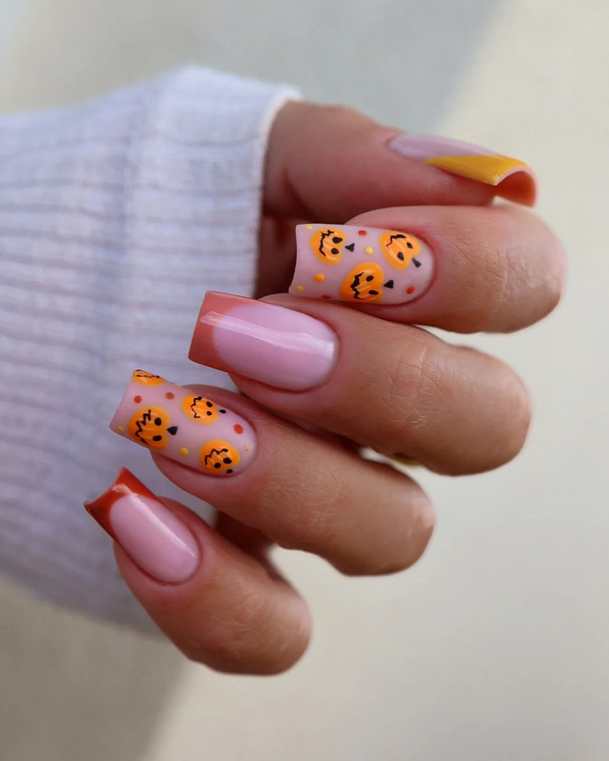 fall nails with pumpkins 2026 Playful Pink Nails With Mini Pumpkin Faces