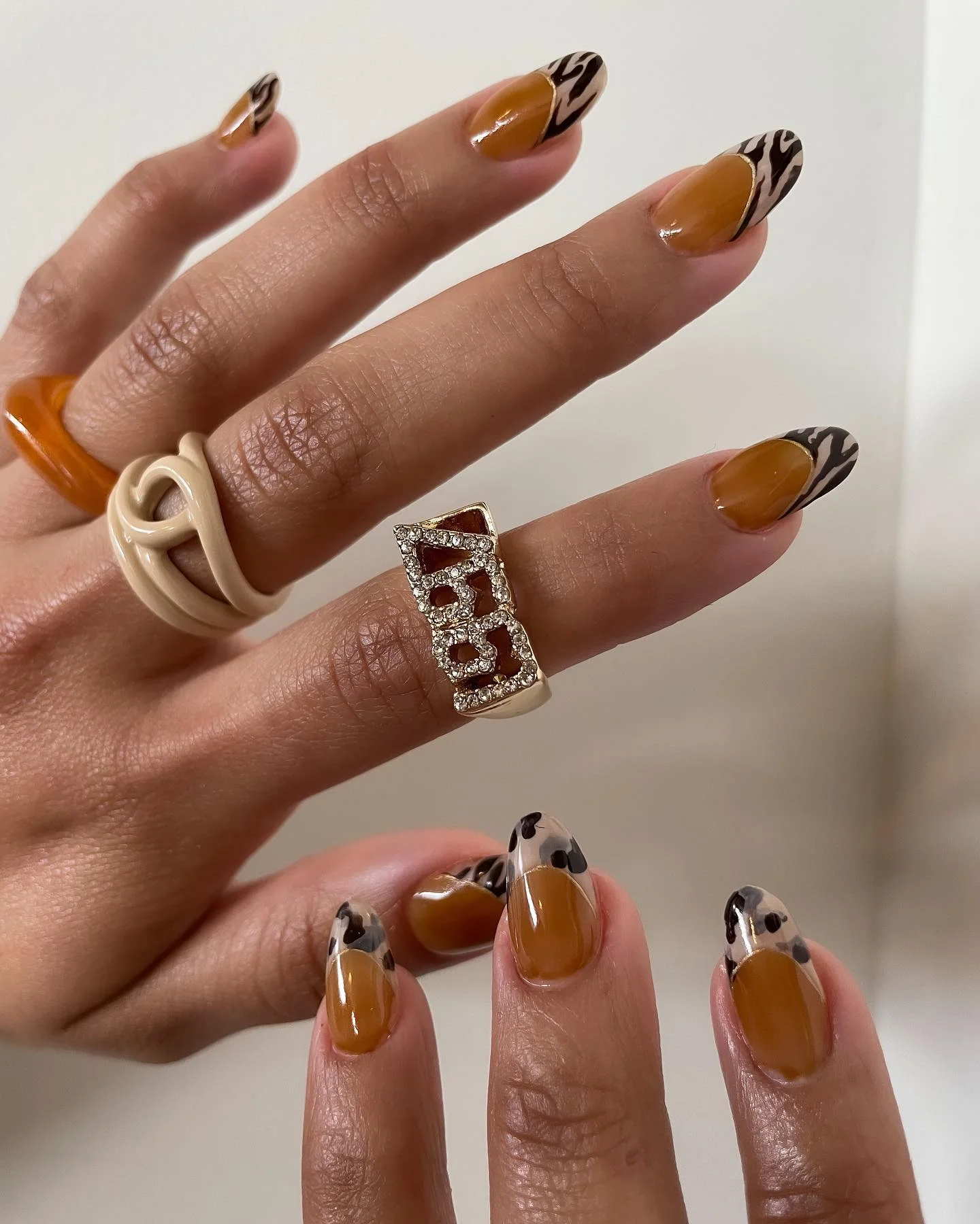 fall french nails 2026 Earthy Animal Print French With Caramel Tones