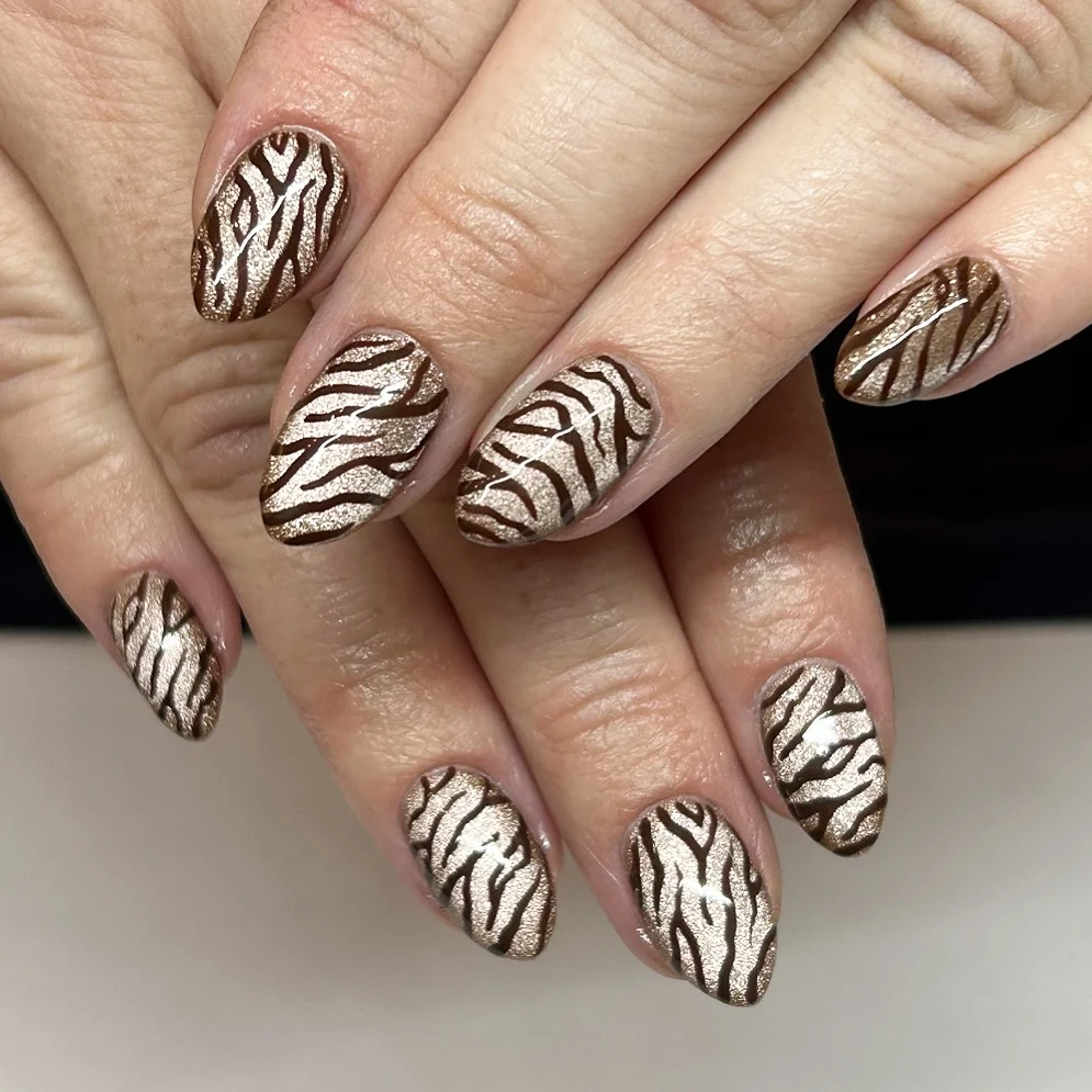 fall nail inspiration 2026 Metallic Zebra Nails With Cozy Espresso Energy