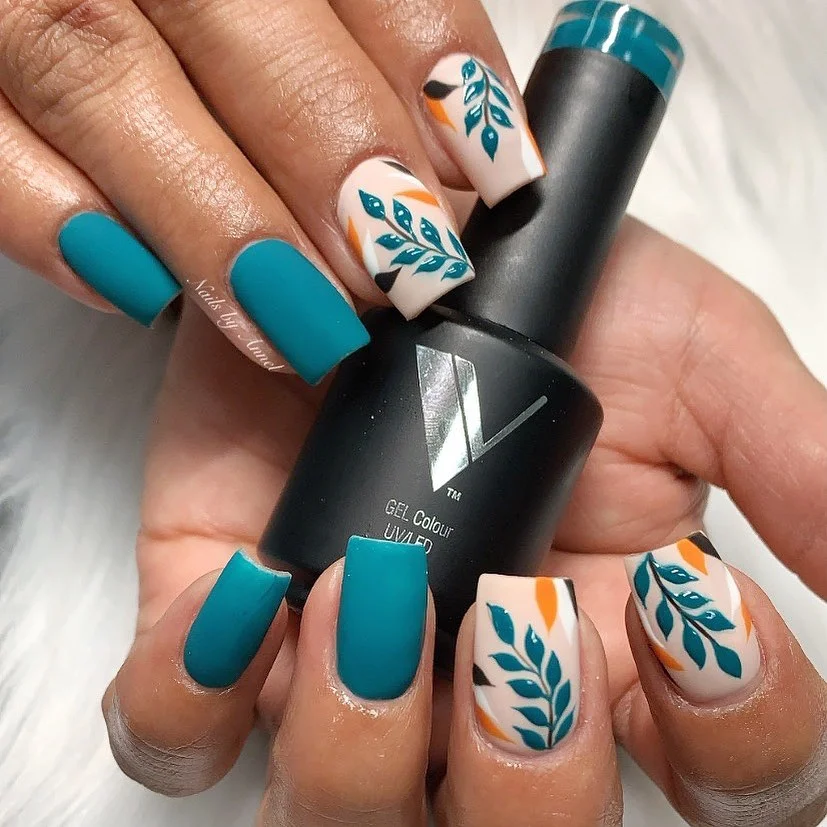 matte fall nails design 2026 Teal Leaves On A Cream Base For A Graphic Fall Accent