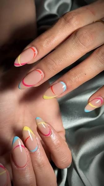 Soft nude base + playful pastel lines = the perfect balance of elegance and fun. 💛🩵💗, Minimal yet eye-catching, these abstract almond nails are made to brighten every outfit and every mood., If you ...