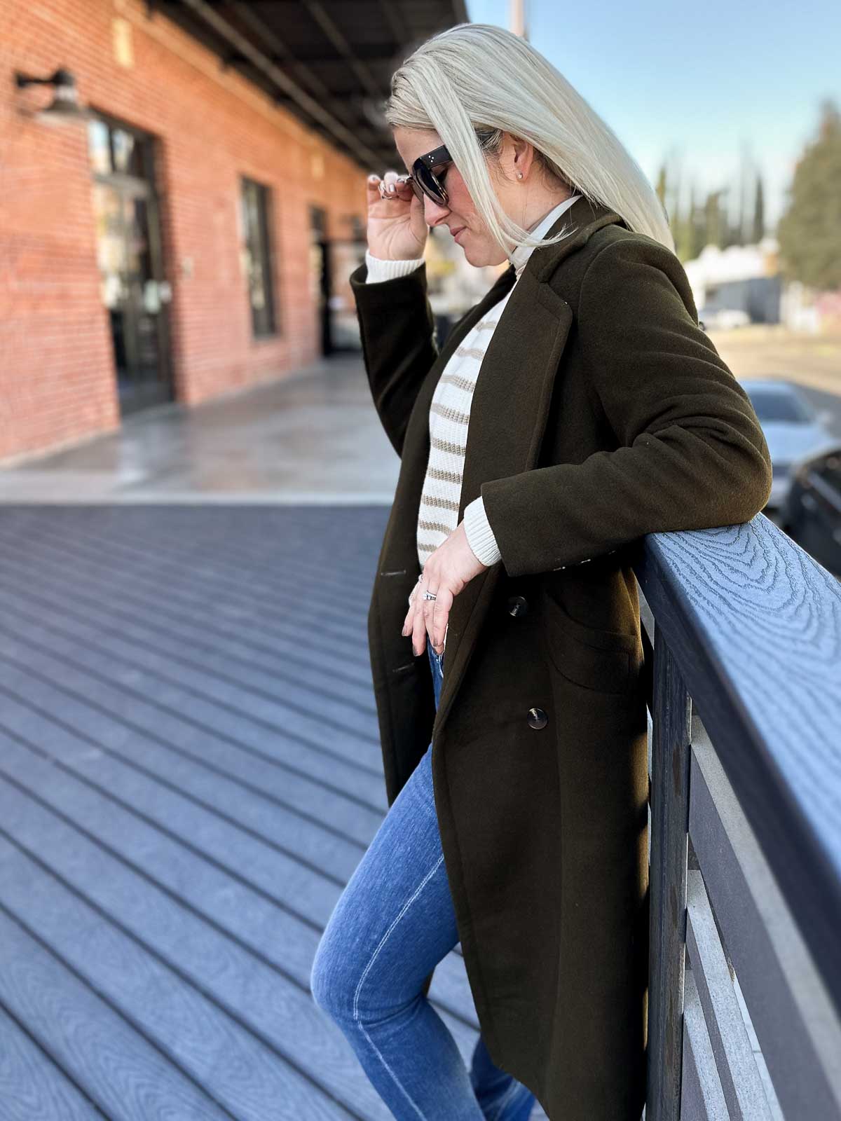 Classic Winter Layering: Olive Green Coat with Striped Sweater and Jeans — Winter Capsule Wardrobe