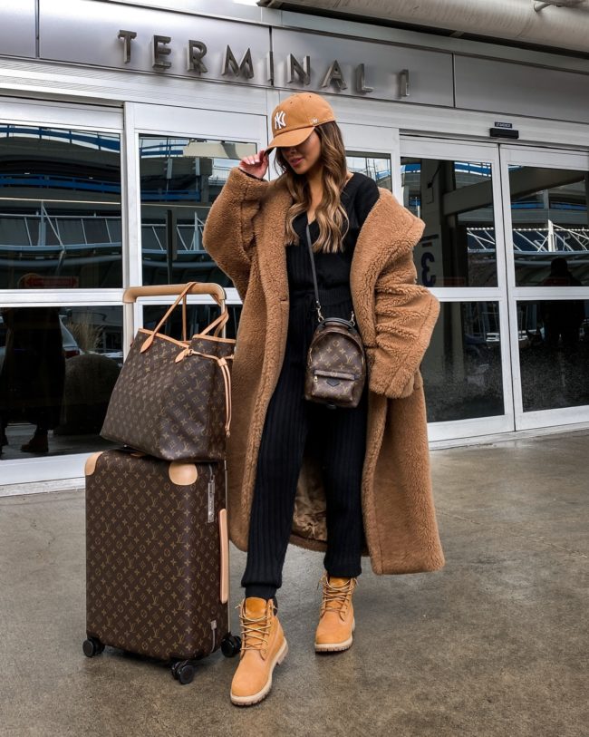 Oversized Teddy Coat Over a Black Jumpsuit — Winter Airport Outfits