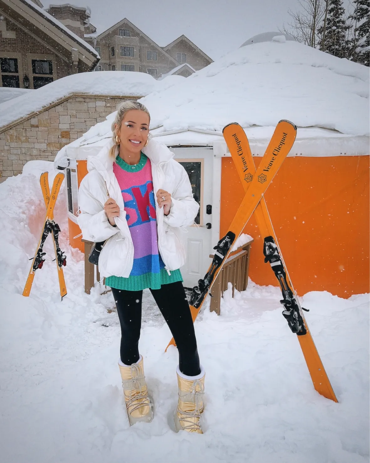 White Puffer Jacket Over Colorful Striped Sweater and Gold Moon Boots White Puffer Jacket Over Colorful Striped Sweater and Gold Moon Boots — Apres Ski Outfits