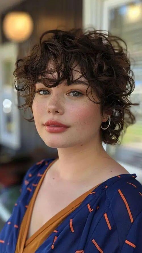 Textured Curly Pixie with Bangs Textured Curly Pixie with Bangs — Winter Haircuts for Round Faces