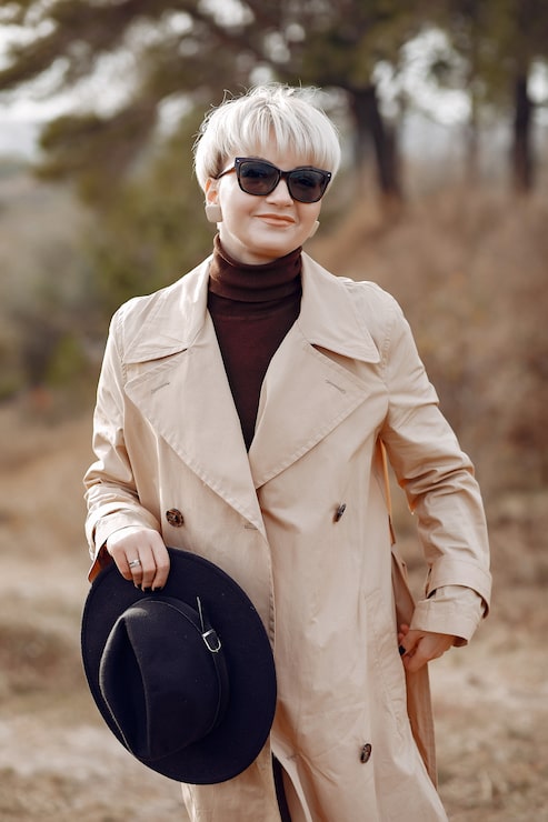 Beige Trench Coat Over Brown Turtleneck and Sneakers Beige Trench Coat Over Brown Turtleneck and Sneakers — Casual Winter Outfits for Women Over 50