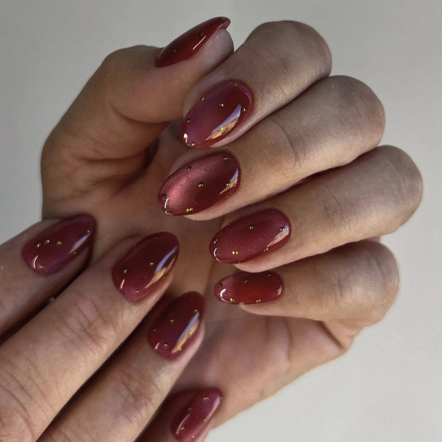 Deep Red Cat Eye with Gold Studs Deep Red Cat Eye with Gold Studs — Winter Cat Eye Nails