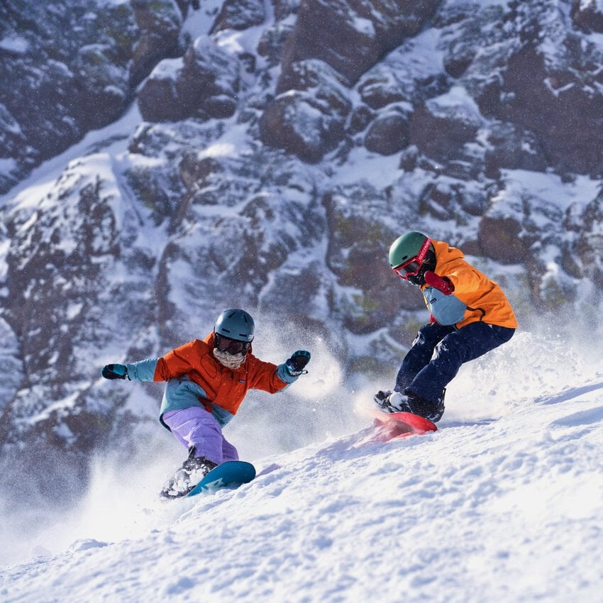 Dynamic Snowboarding Duo in Orange, Teal, and Purple Gear Dynamic Snowboarding Duo in Orange, Teal, and Purple Gear — Snowboarding Outfits