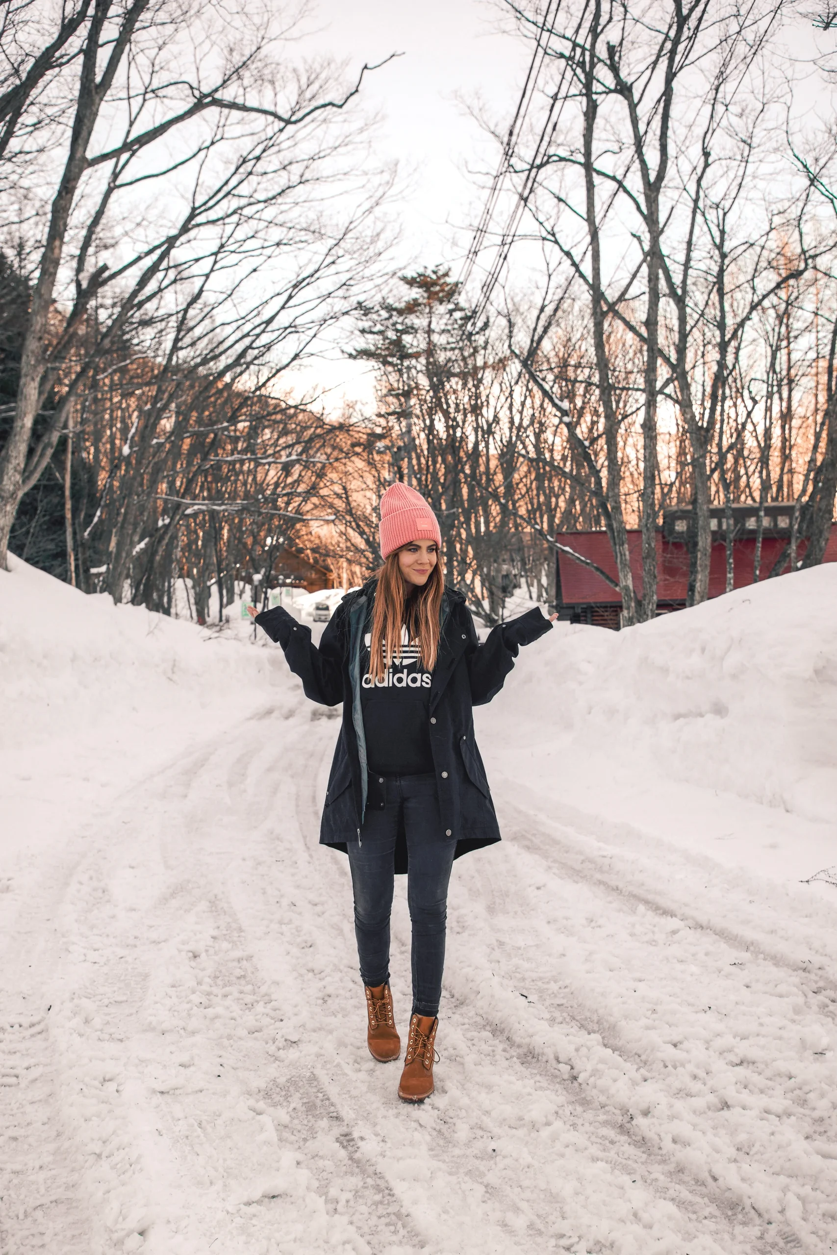 Navy Parka Over Adidas Hoodie with Brown Boots and Pink Beanie — Japan Winter Outfits