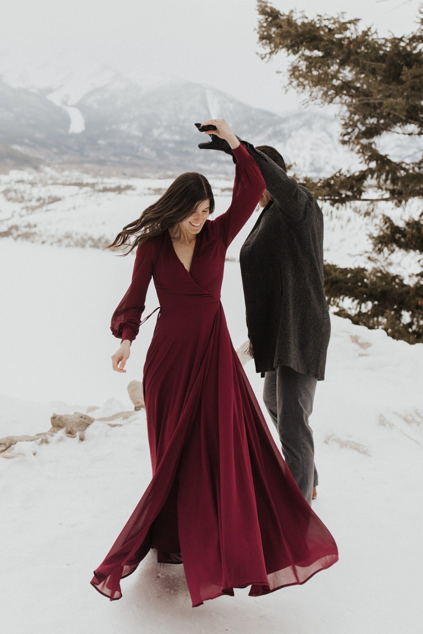 Flowing Red Wrap Dress with Charcoal Coat for an Engagement Shoot Flowing Red Wrap Dress with Charcoal Coat for an Engagement Shoot — Winter Photoshoot Outfits