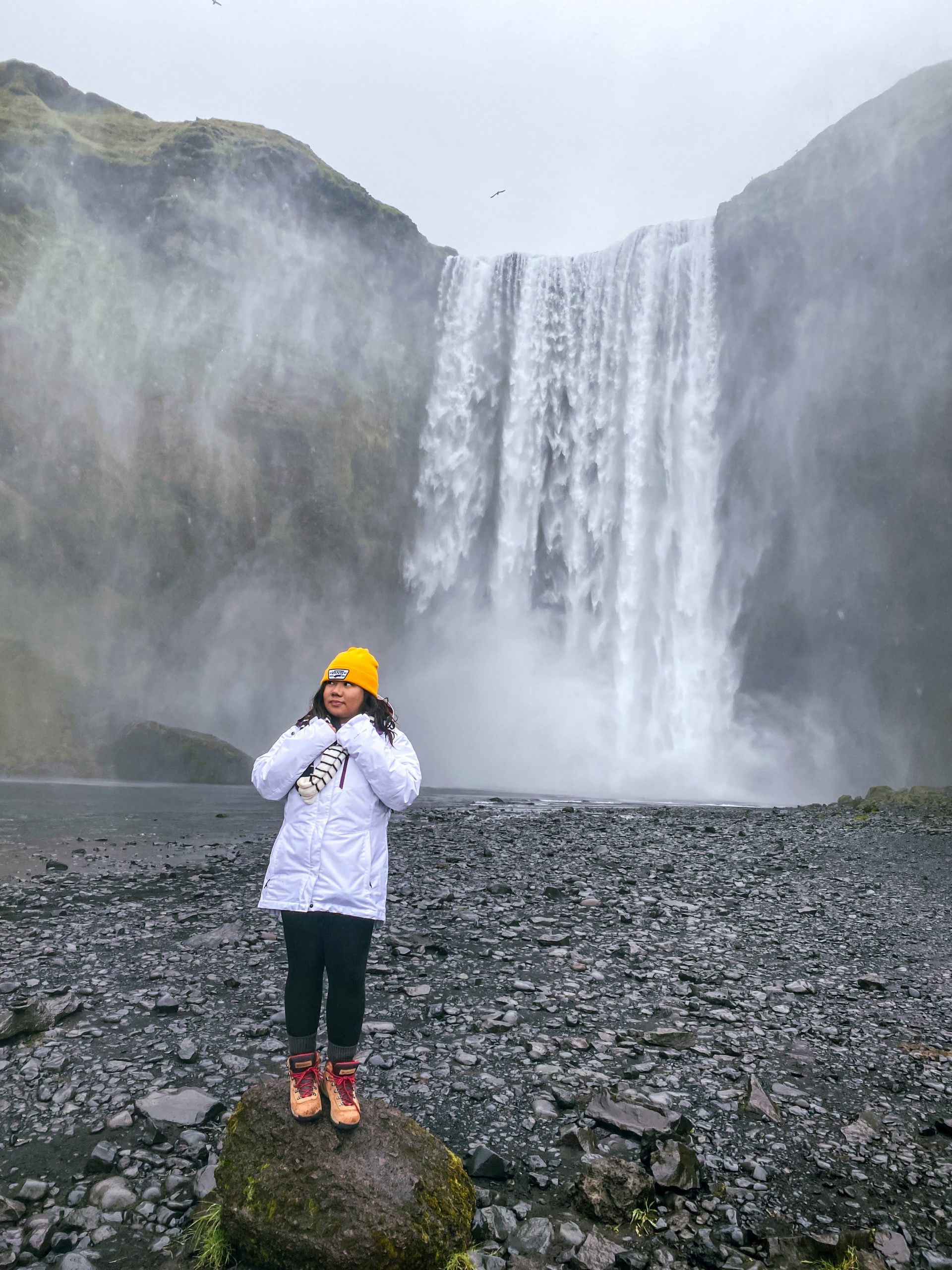 White Puffer Jacket with Red Boots and Yellow Beanie — Iceland Winter Outfits