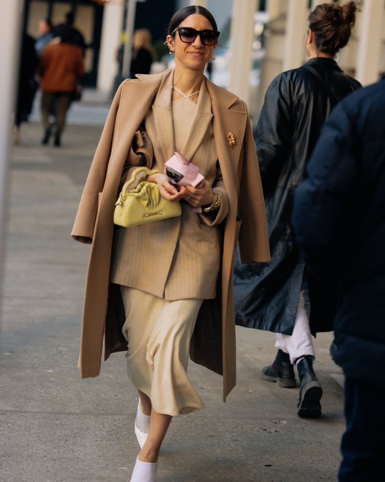 Camel Coat Draped Over Pinstripe Blazer and Cream Skirt Camel Coat Draped Over Pinstripe Blazer and Cream Skirt — Winter Work Outfits
