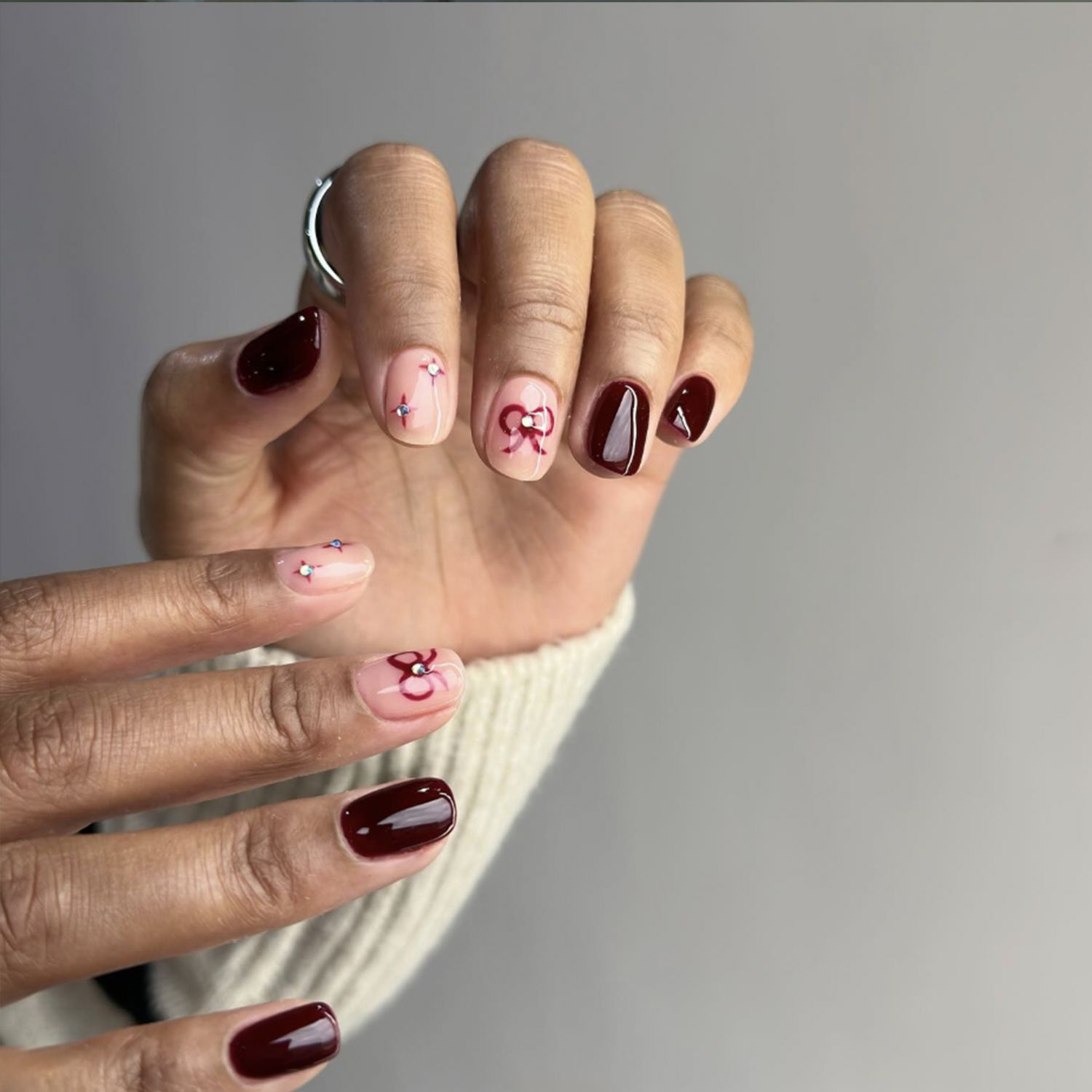 Short Oval Burgundy Red Bow Nails Short Oval Burgundy Red Bow Nails — Winter Nail Colors for Women Over 60
