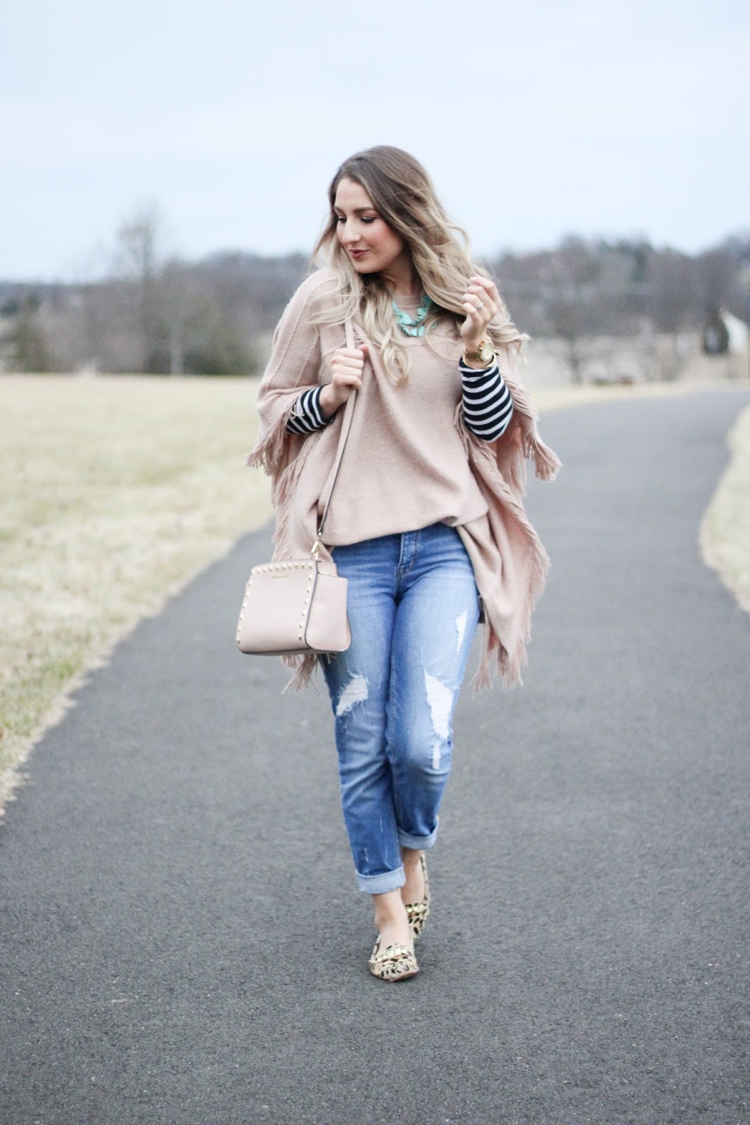 Fringed Poncho Over Striped Shirt and Distressed Jeans — Winter to Spring Transition Outfits