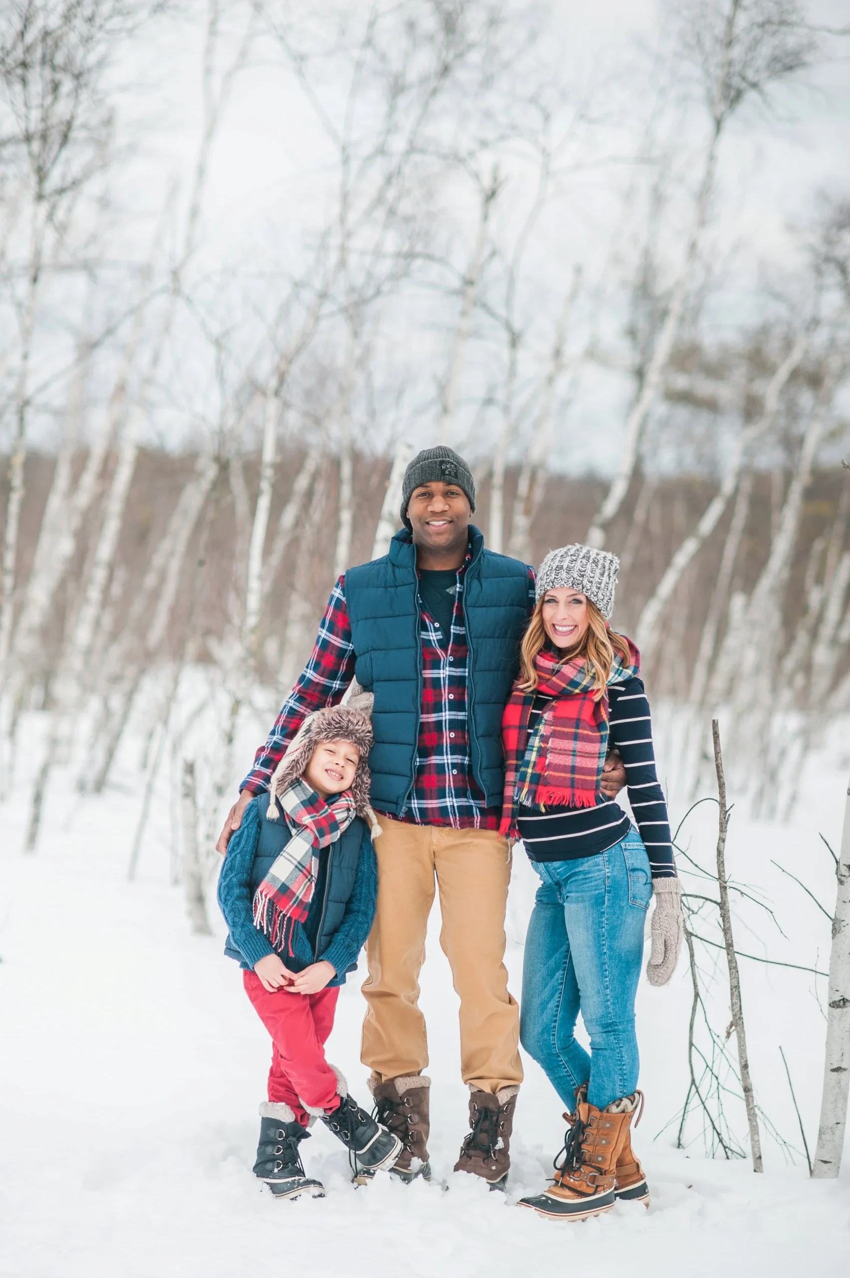 Coordinated Plaid Scarves and Puffer Vests for a Snowy Family Outing Coordinated Plaid Scarves and Puffer Vests for a Snowy Family Outing — Winter Family Photo Outfits