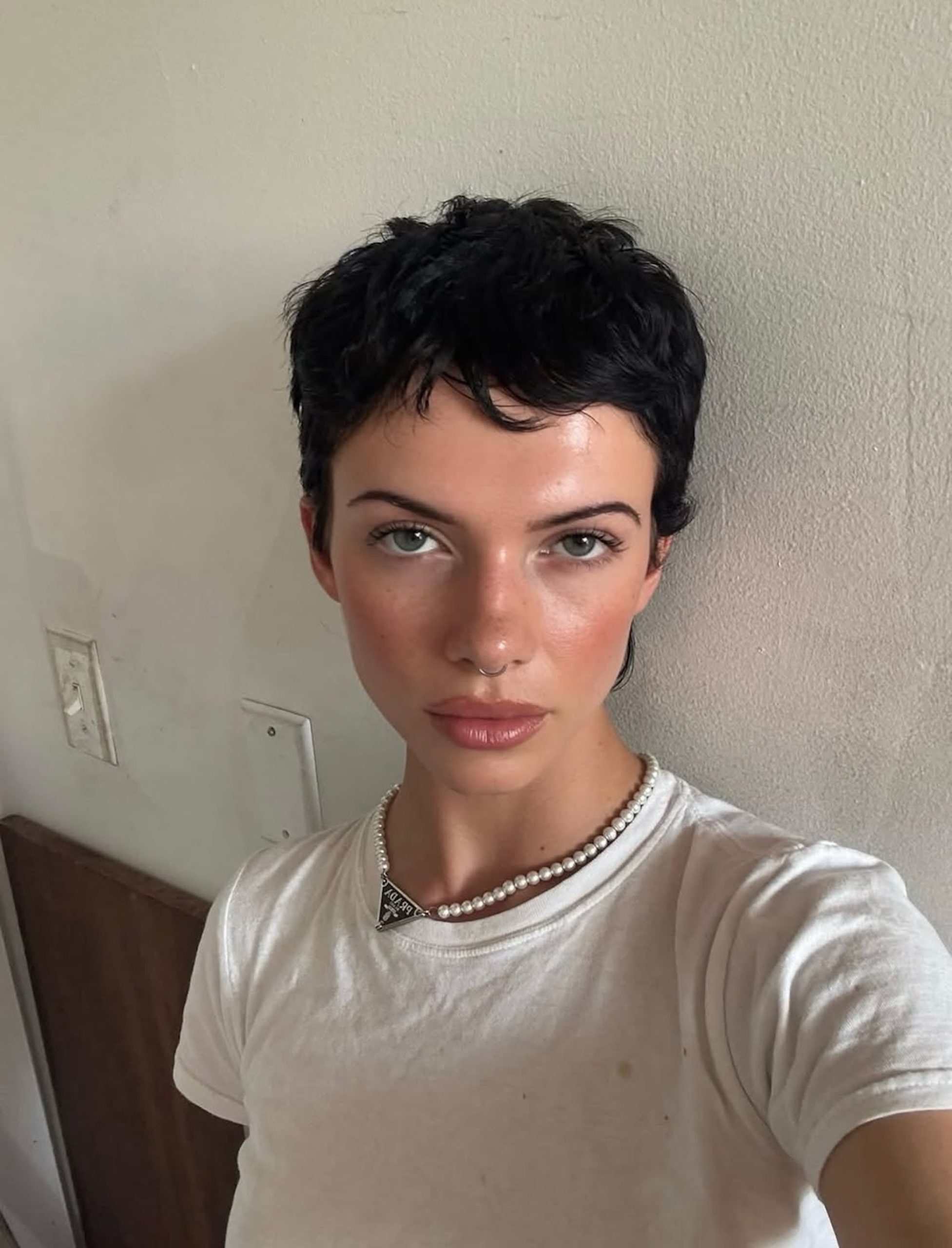 Ear Textured Black Pixie With Wispy Bangs Ear Textured Black Pixie With Wispy Bangs — Winter Pixie Haircuts