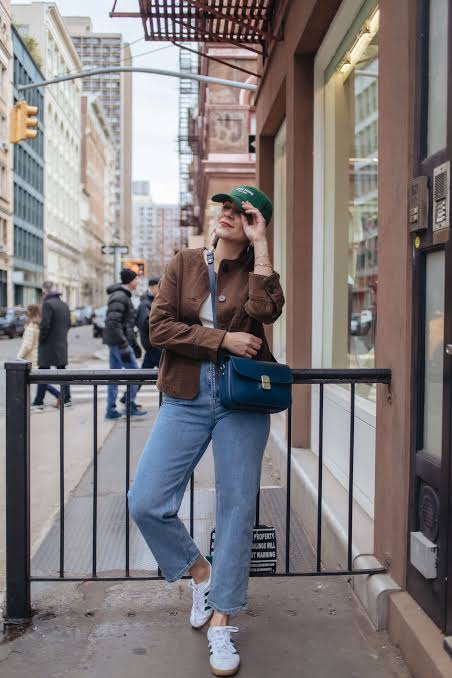 Brown Jacket with White Top, Jeans, and Green Cap — Winter to Spring Transition Outfits