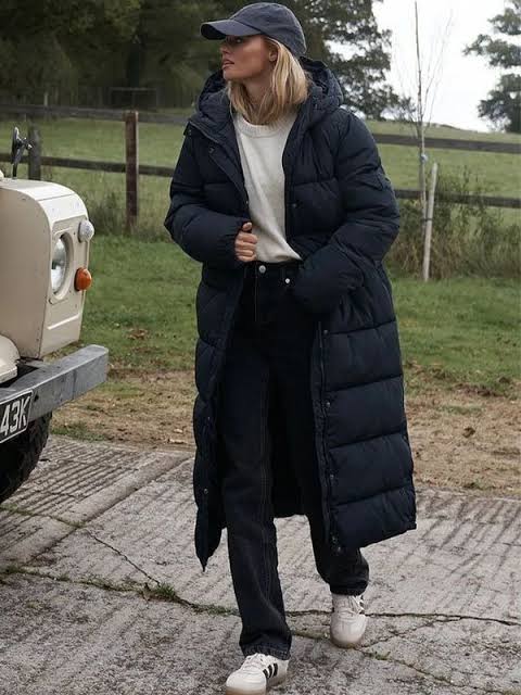 Navy Puffer with Cream Sweater and Baseball Cap — Long Puffer Coat Outfits