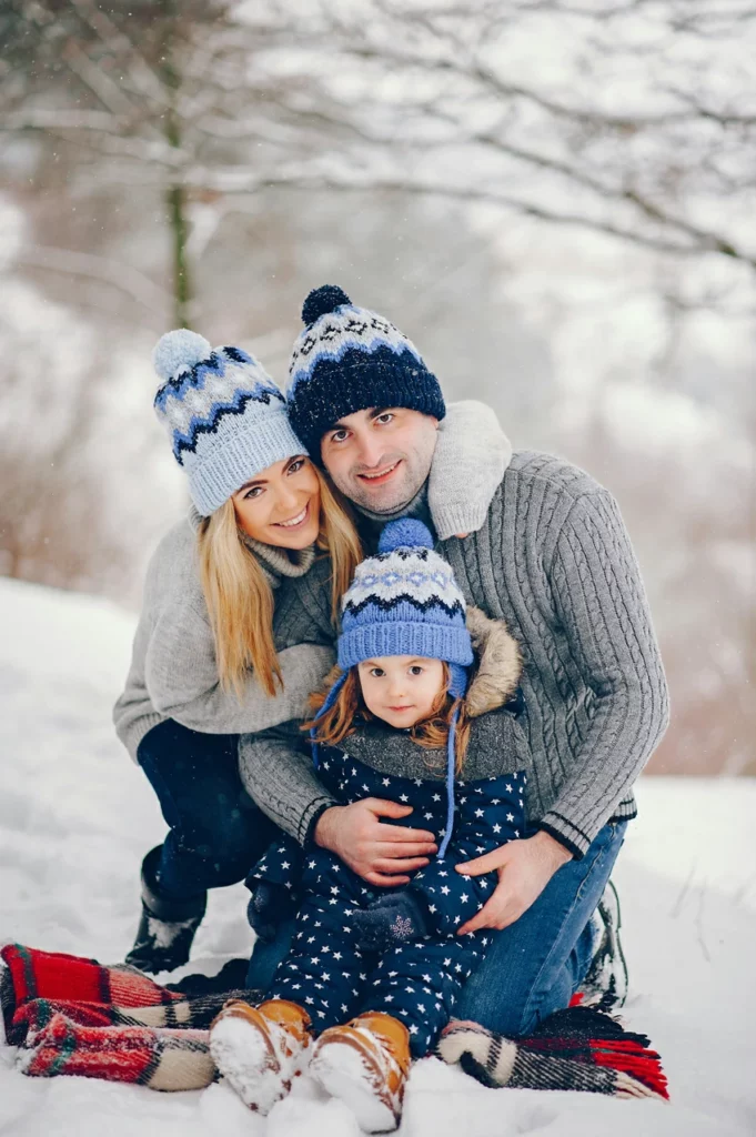 Matching Blue Knit Hats with Grey Sweaters for a Cohesive Family Look Matching Blue Knit Hats with Grey Sweaters for a Cohesive Family Look — Winter Family Photo Outfits