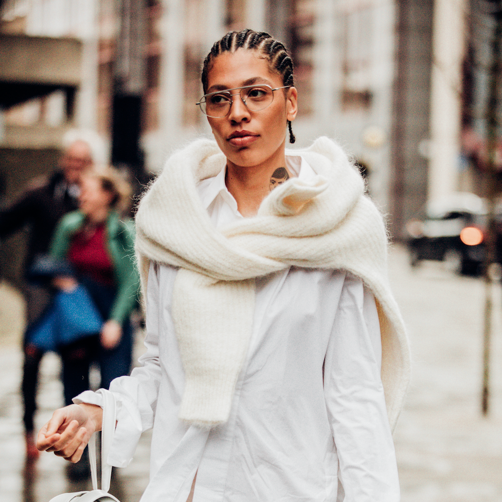 Chunky Knit Sweater Draped Over White Shirt — Winter to Spring Transition Outfits