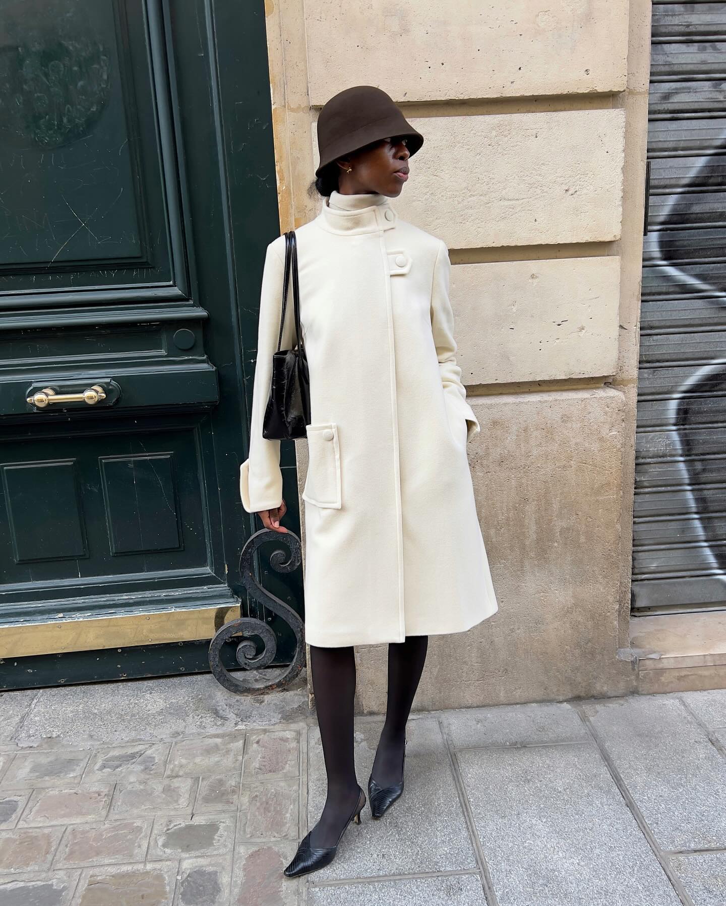 Cream High-Neck Coat Over Black Tights with Cloche Hat Cream High-Neck Coat Over Black Tights with Cloche Hat — Neutral Winter Outfits