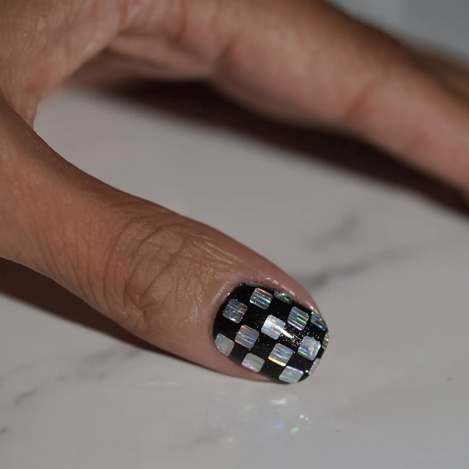 Holographic Checkerboard Thumb Holographic Checkerboard Thumb — Winter Squoval Nails