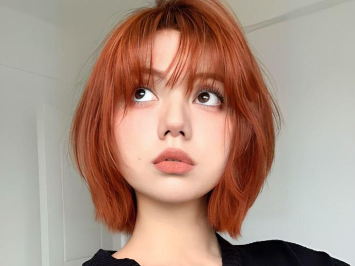 Vibrant Copper Bob with Wispy Bangs Vibrant Copper Bob with Wispy Bangs — Winter Haircuts for Round Faces