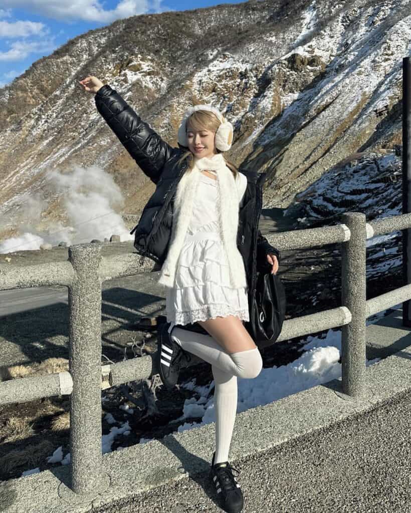 Black Puffer Jacket over White Lace Dress with Black Sneakers — Japan Winter Outfits