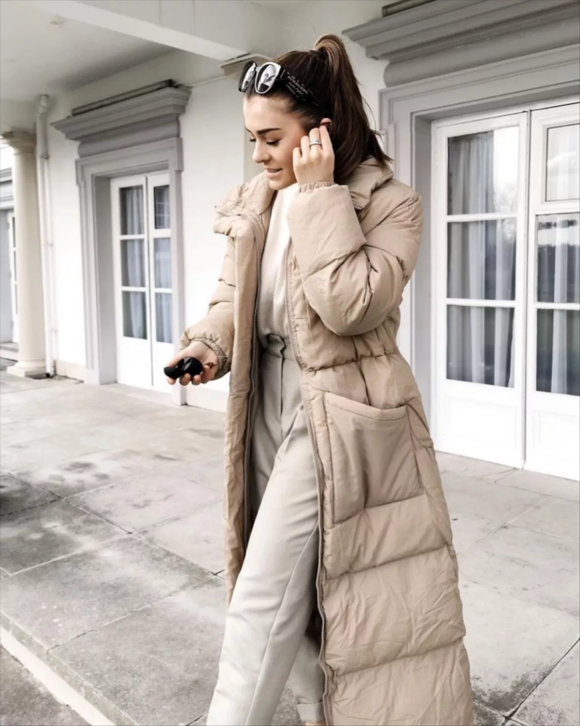 Chic Beige Puffer with Cinched Waist and Wide-Leg Trousers — Long Puffer Coat Outfits