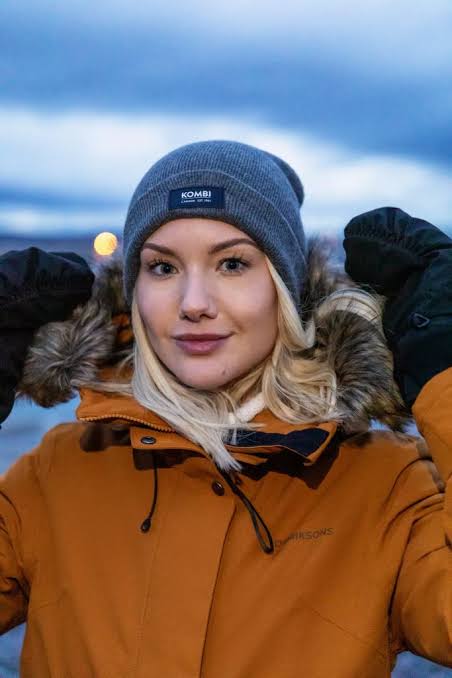 Vibrant Orange Puffer with Fur-Trimmed Hood — Iceland Winter Outfits