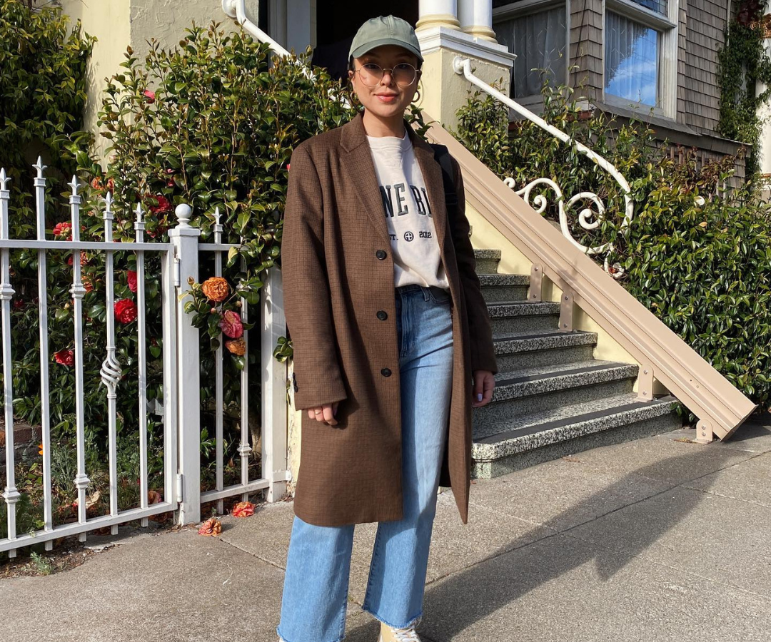 Plaid Coat Over Graphic T-Shirt and Jeans — Winter to Spring Transition Outfits
