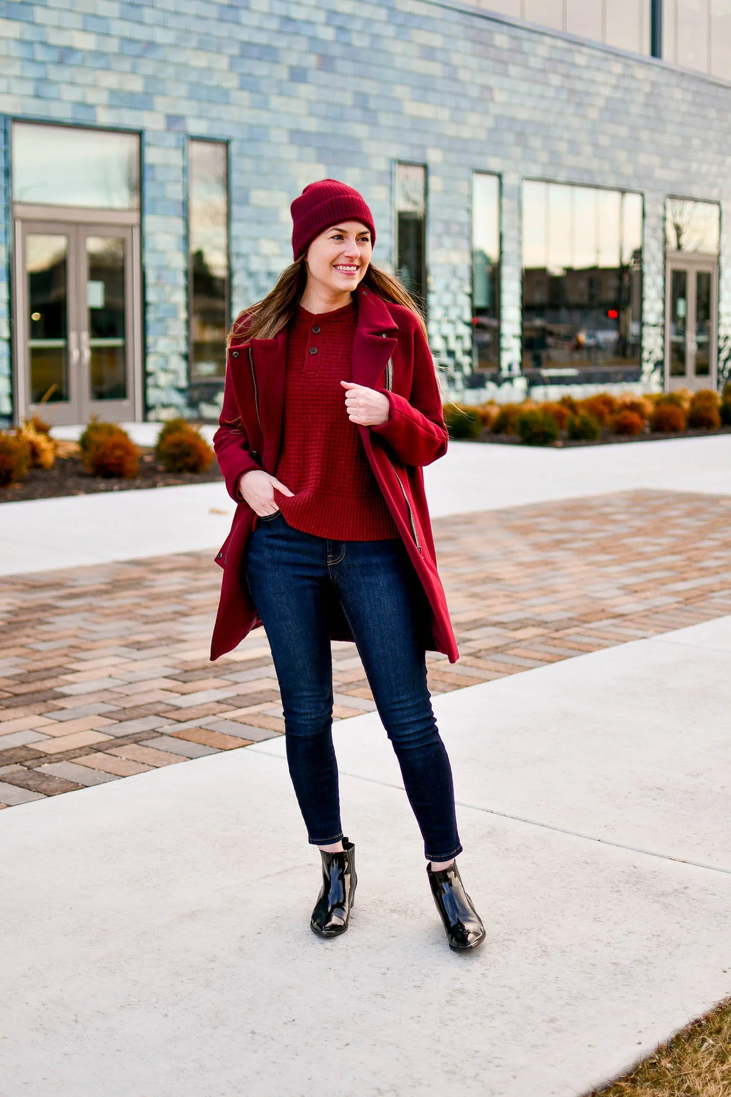 Burgundy Knit Sweater and Beanie with Matching Coat for a Cohesive Dinner Look — Winter Dinner Outfits