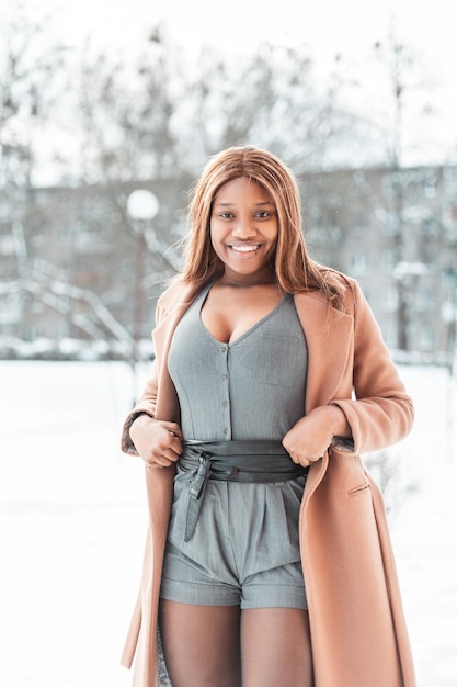 Tan Wool Coat Over a Grey Romper with Black Belt Tan Wool Coat Over a Grey Romper with Black Belt — Winter Outfits for Black Girls