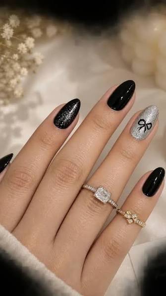 Medium Oval Black with Silver Glitter and Bow Medium Oval Black with Silver Glitter and Bow — black nail ideas