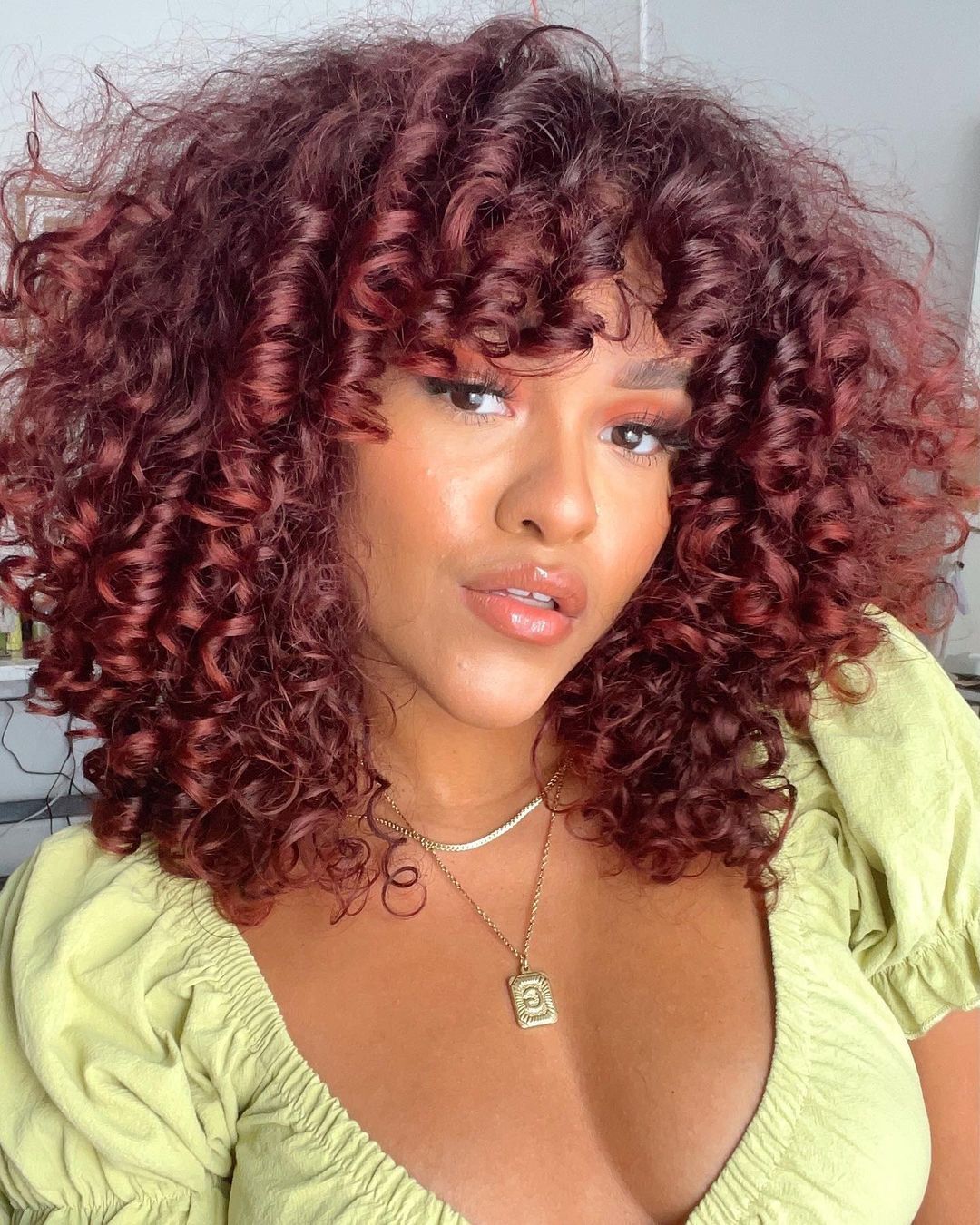 Fiery Auburn Curls With Curly Bangs — Winter Auburn Hair Color