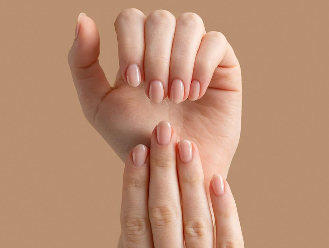 Sheer Nude Beige Glossy Short Oval Nails, One Resting Over The Other — Beige Nails