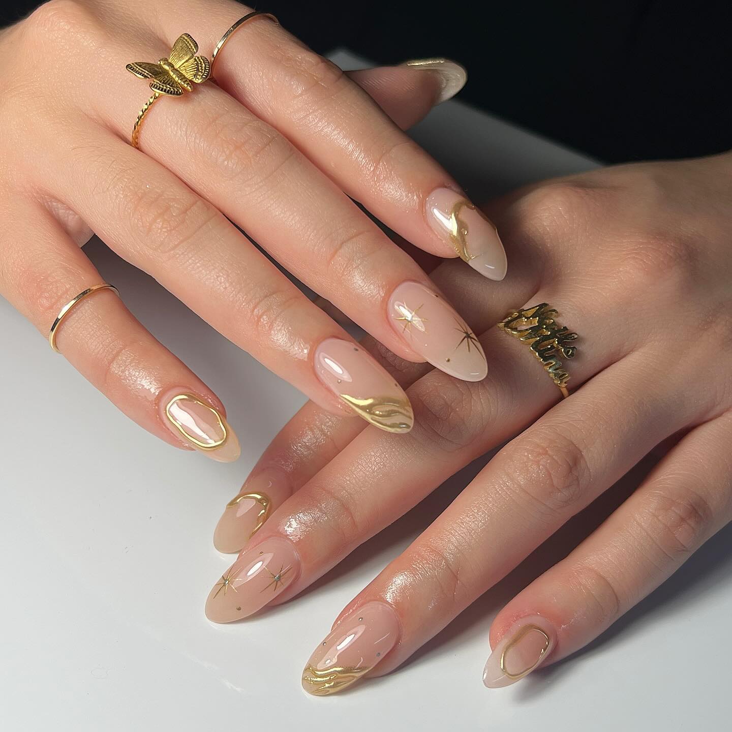 Medium Almond Nude With Gold French Tips And Stars — Birthday Nails Almond