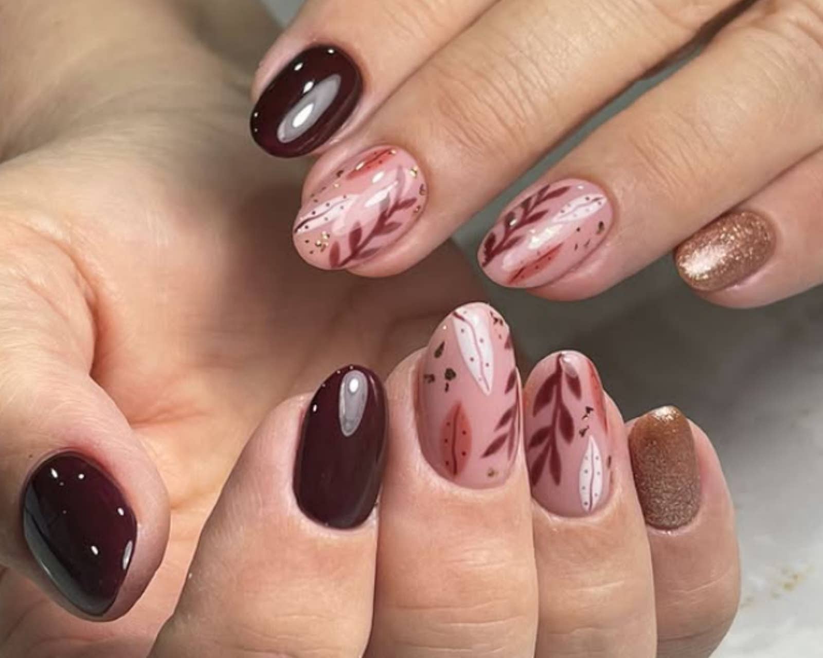 Short Oval Burgundy Leaf Motif Nails — Burgundy Nails
