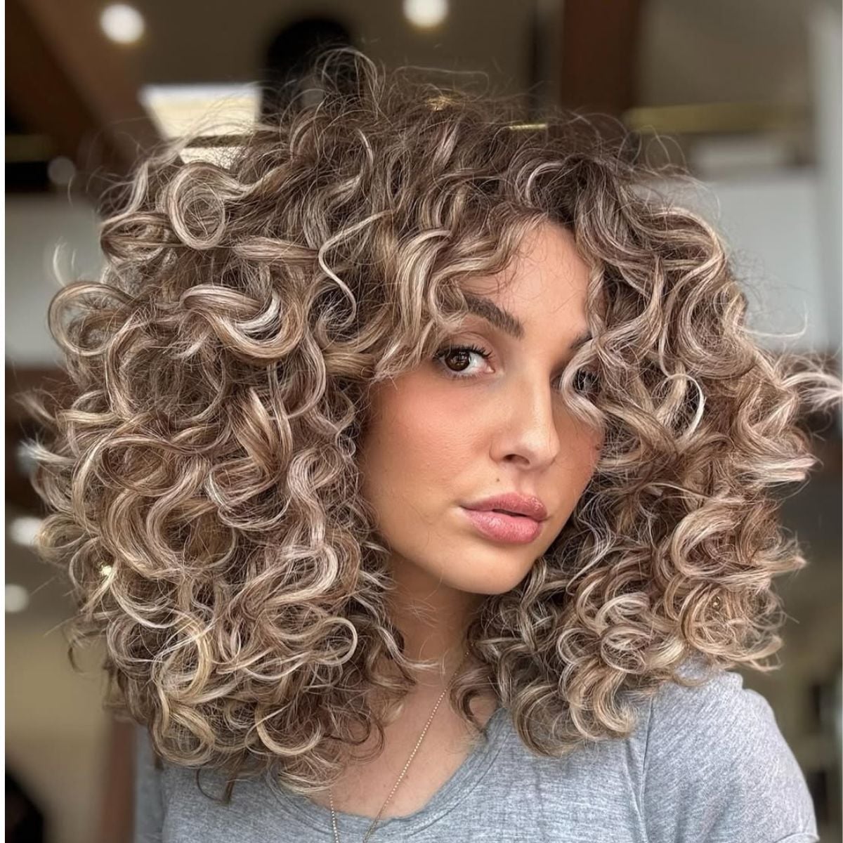 Shoulder Length Layered Curls With Blonde Balayage Shoulder Length Layered Curls With Blonde Balayage — Curly Haircuts