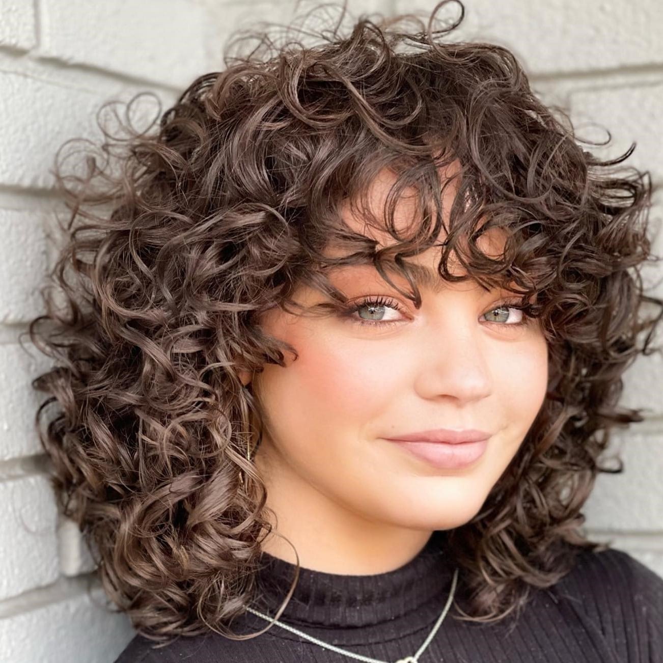 Collarbone Layered Bob With Short Curly Bangs, Side Collarbone Layered Bob With Short Curly Bangs, Side — Curly Haircuts