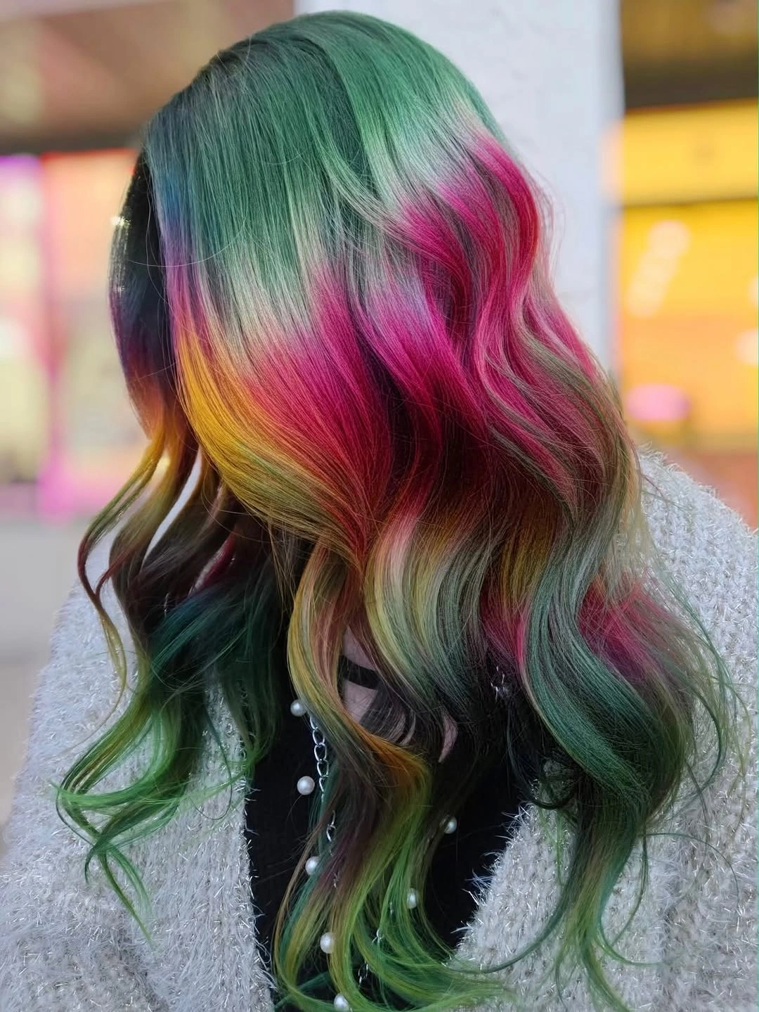 Long wavy hair with green magenta violet and golden yellow sections