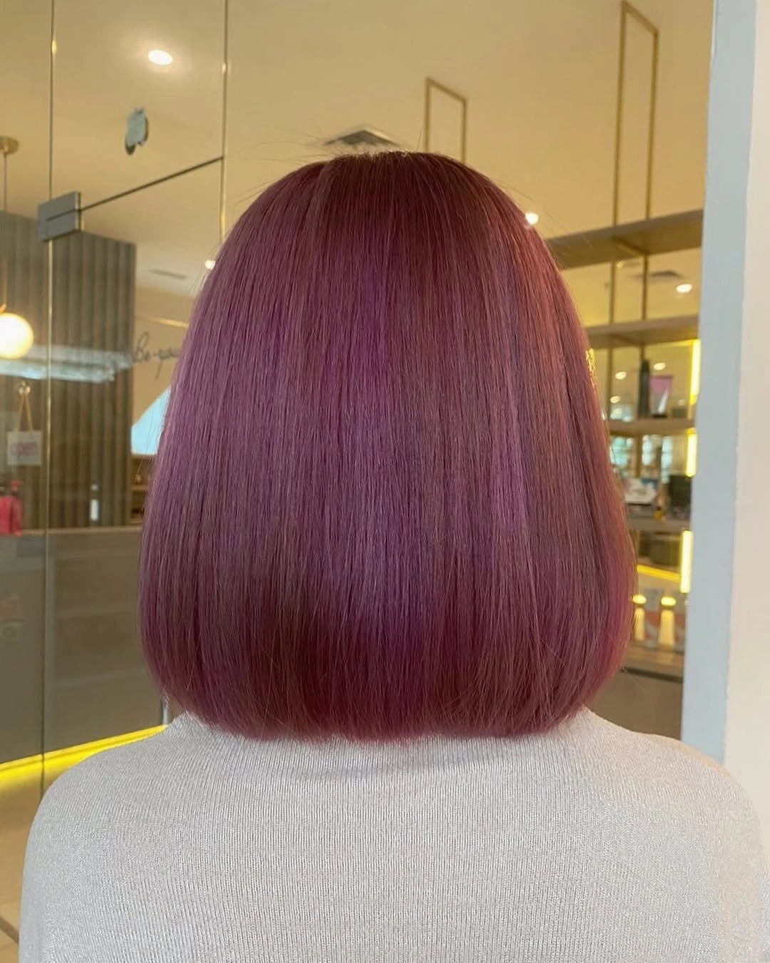 Smooth blunt bob in muted berry purple with wine red reflections